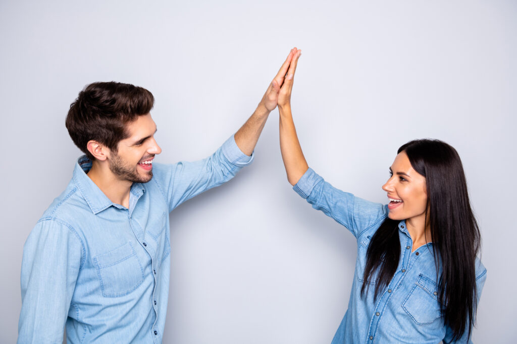 Profile side view portrait of his he her she nice attractive charming lovely cheerful cheery glad couple clapping palms agreement isolated over light white gray pastel color background